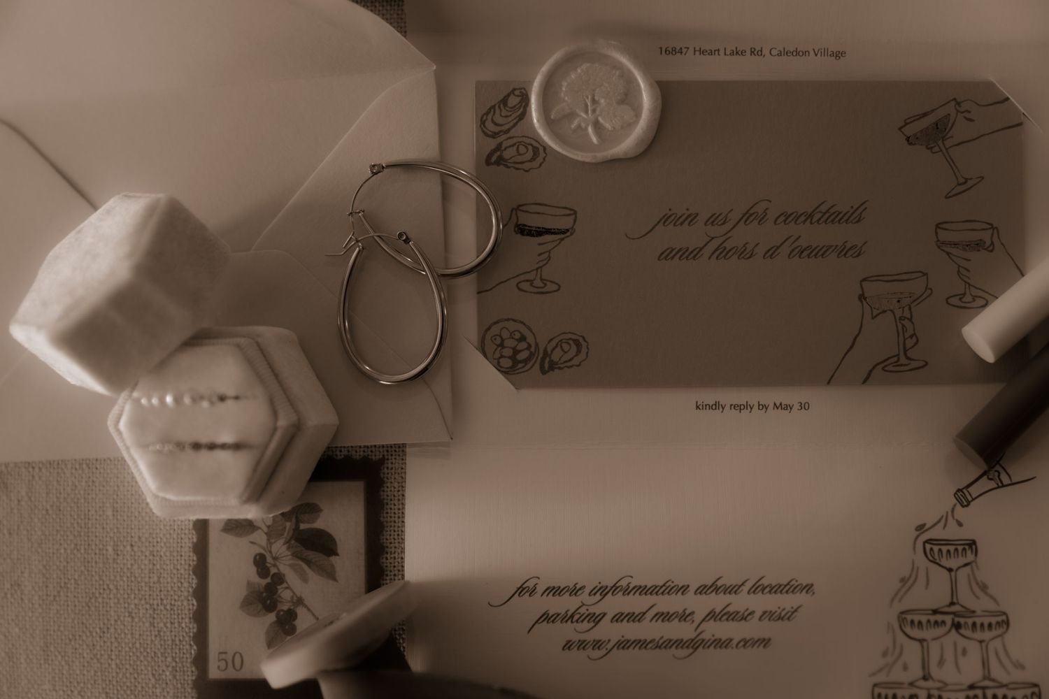 A vintage-styled flat lay of wedding stationery and decorative items arranged on a light surface.