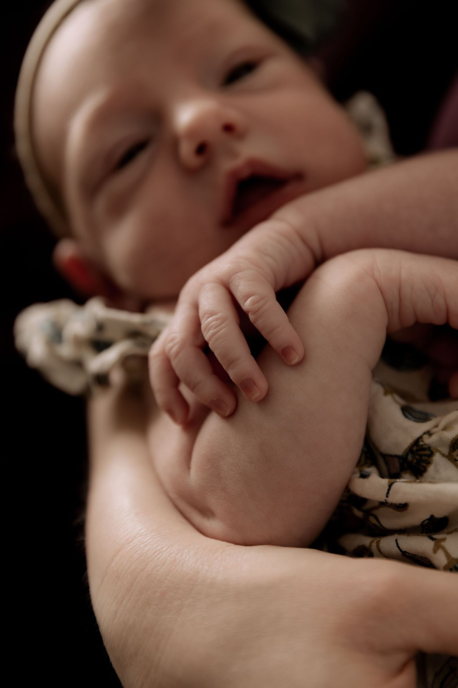 Intimate portrait of small hands grasping in natural light.
