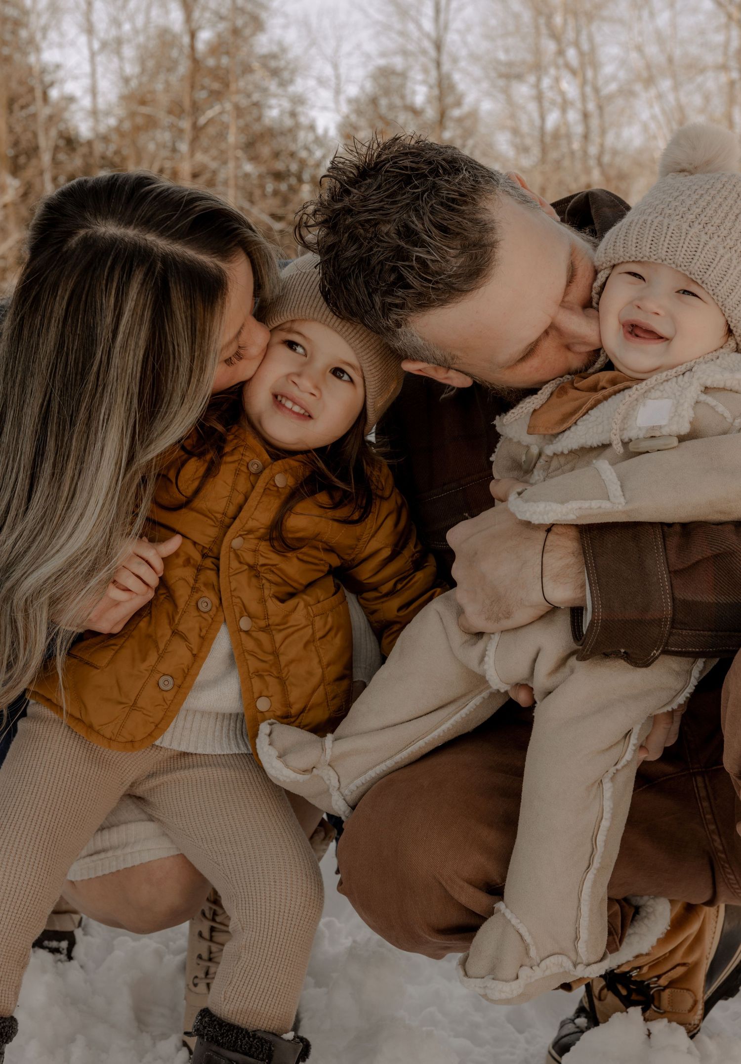 A family shares a tender outdoor moment together on a crisp autumn day.