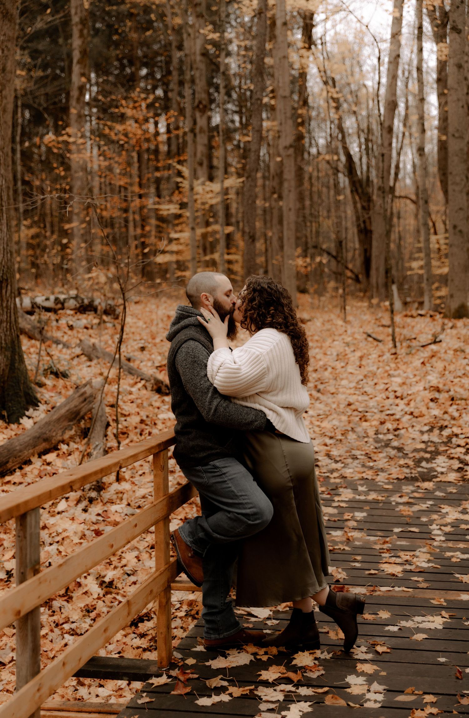Romantic autumn scene on a wooden boardwalk surrounded by fall foliage.