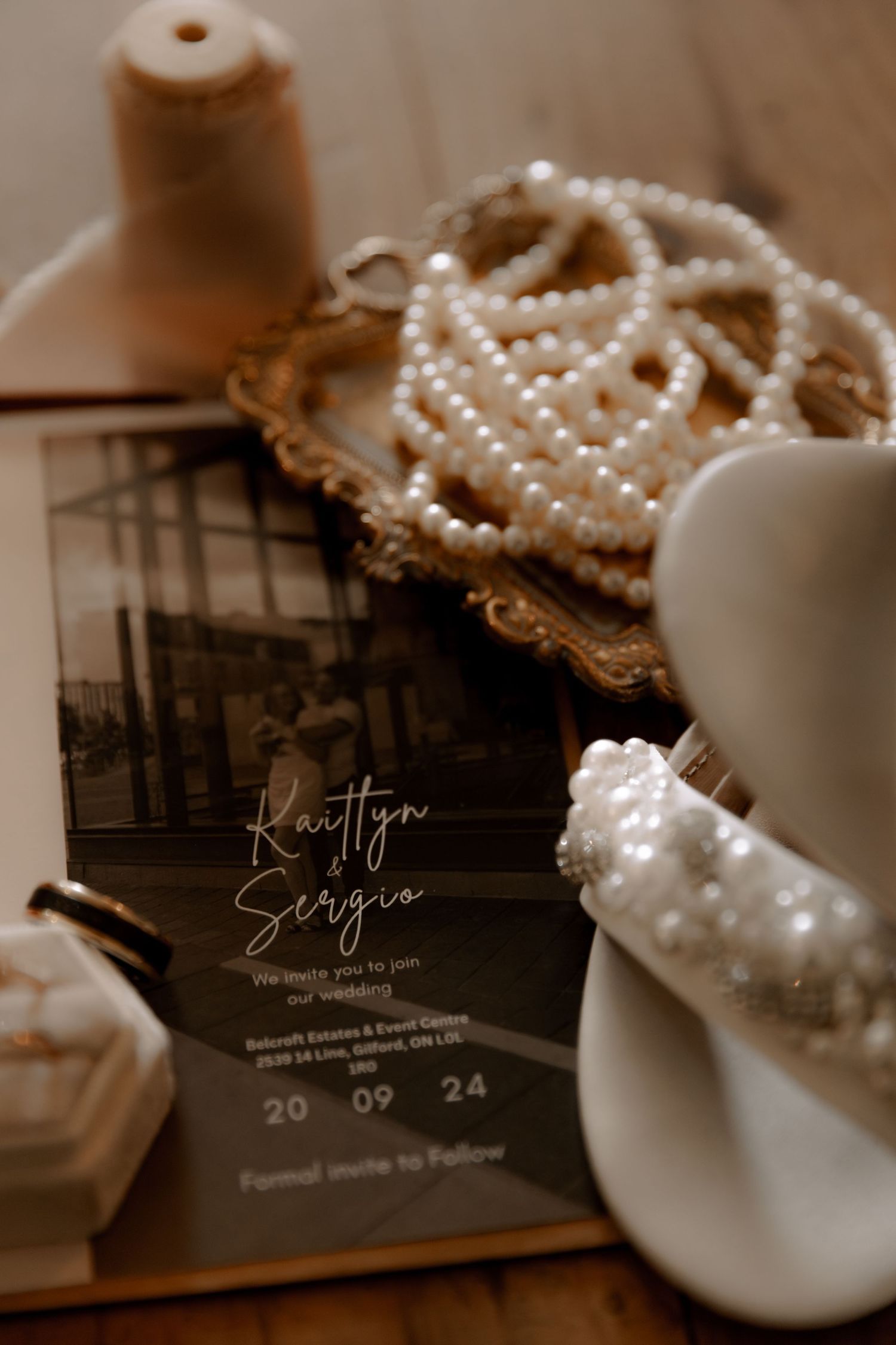 Close-up of wedding stationery with pearl accessories and elegant details.
