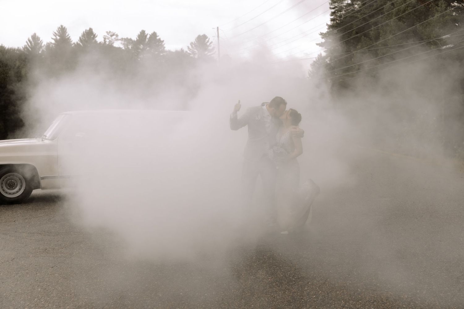 Dreamy sepia wedding photo with couple completely enveloped in dramatic smoke effects.
