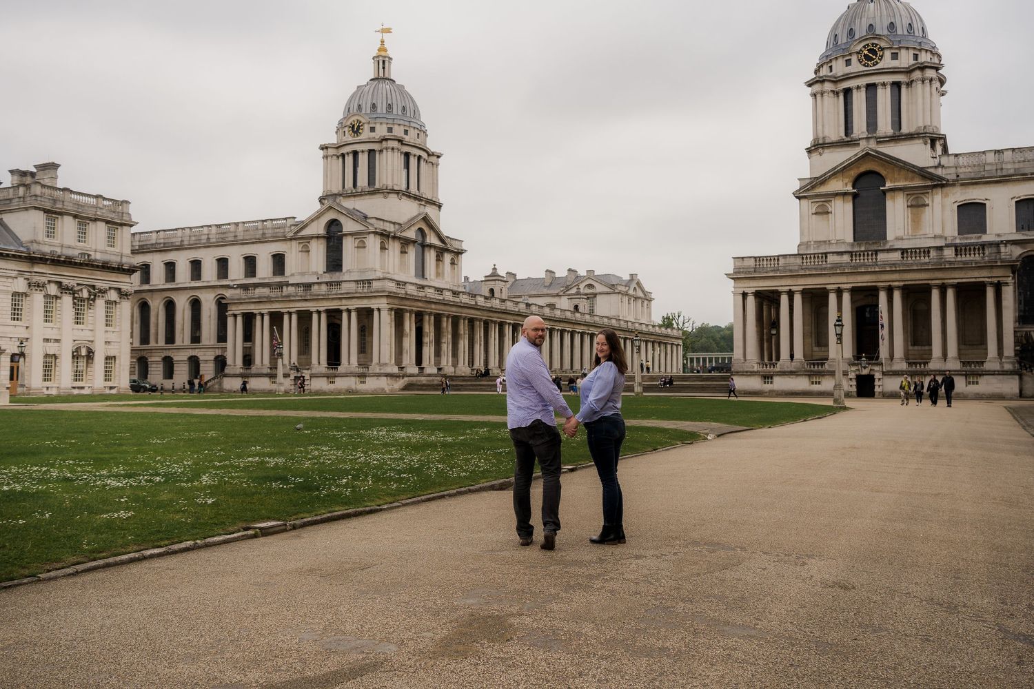 Historic Royal Naval College buildings and grounds in Greenwich, London, showcasing grand architecture and domed structures.