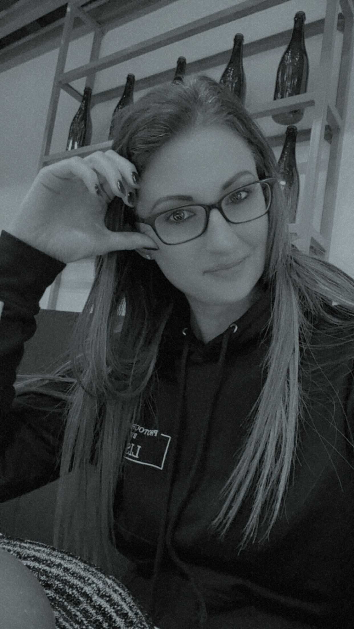 A series of black and white selfie photos showing someone wearing glasses and making playful expressions.