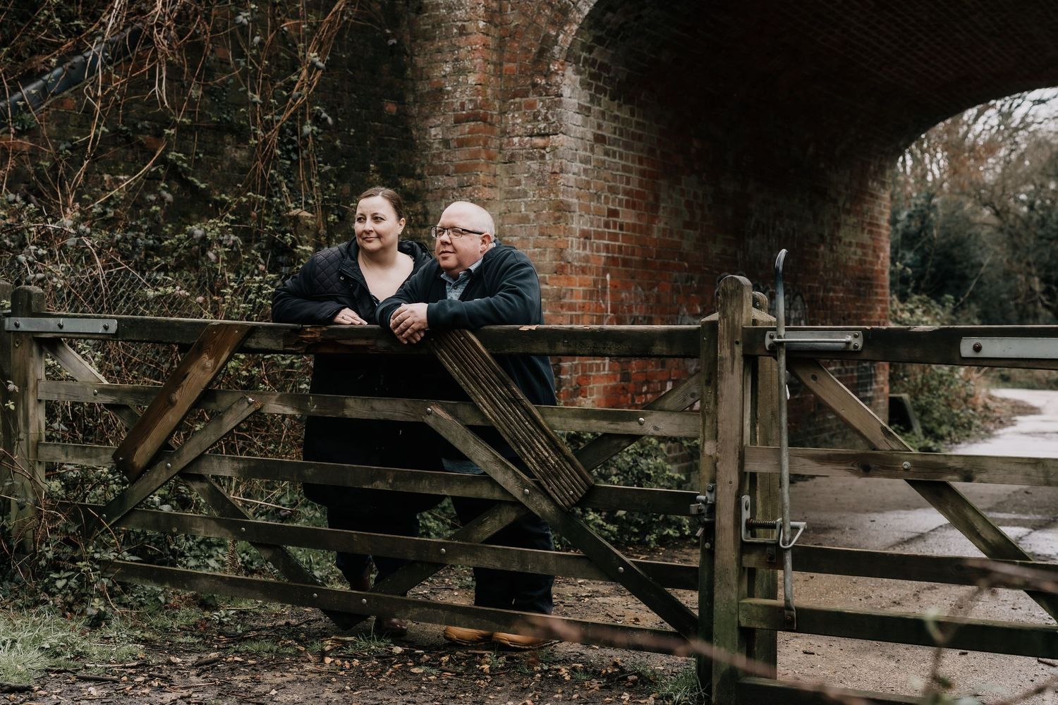 A series of candid moments captured on rustic wooden stairs with brick architecture.