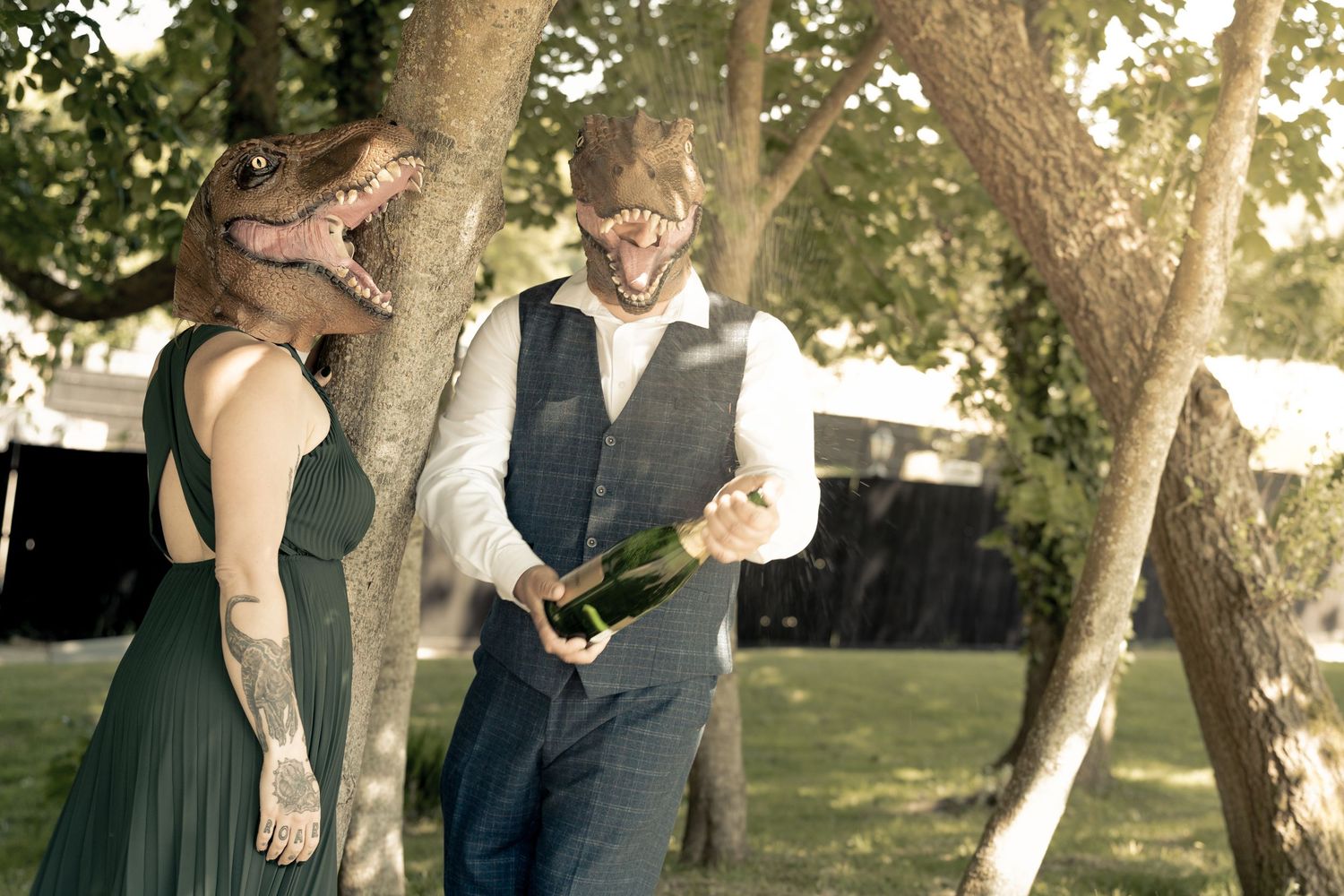 Couple sharing romantic moments under sunlit trees in a park.