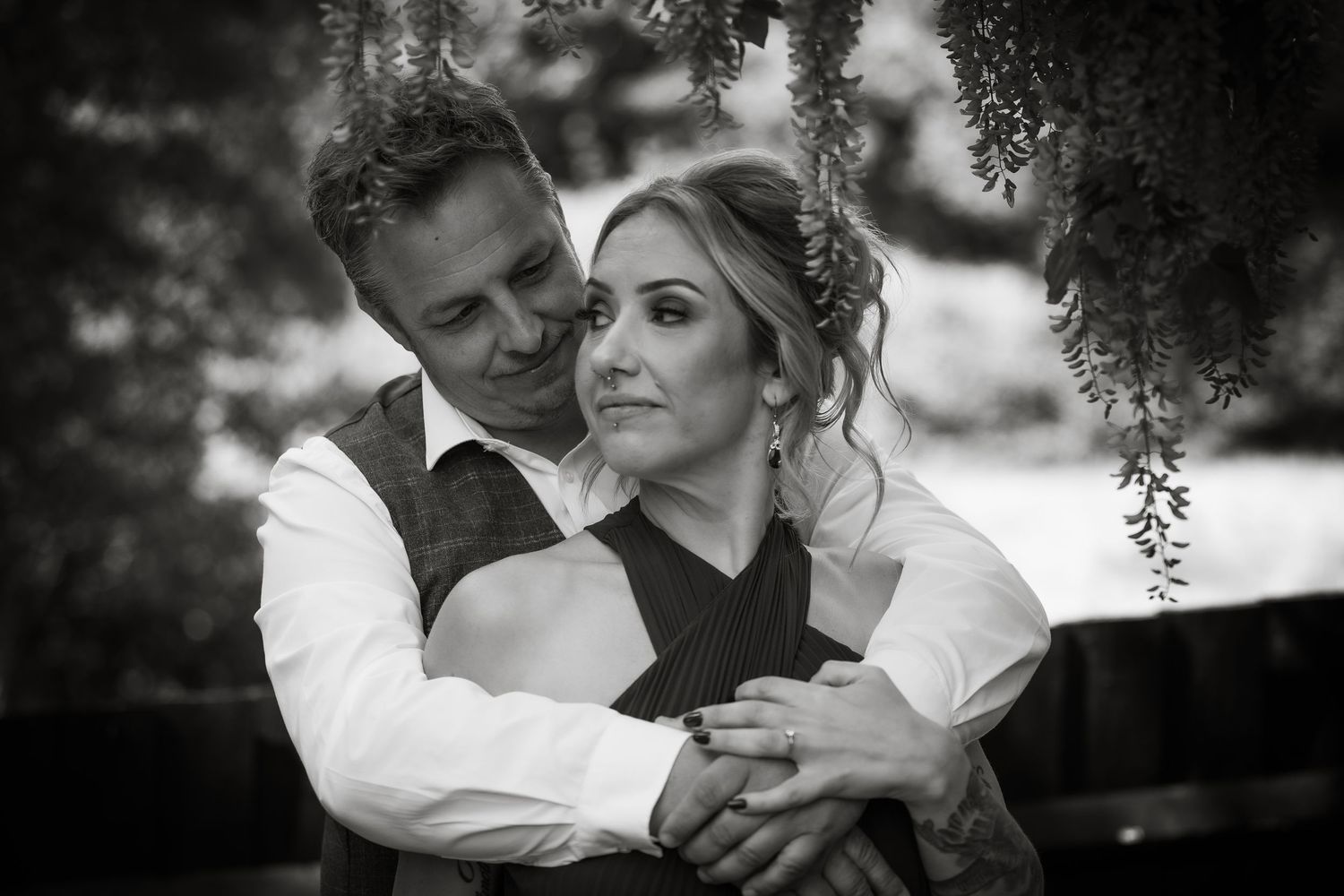 Black and white romantic portraits showing tender moments under tree branches.