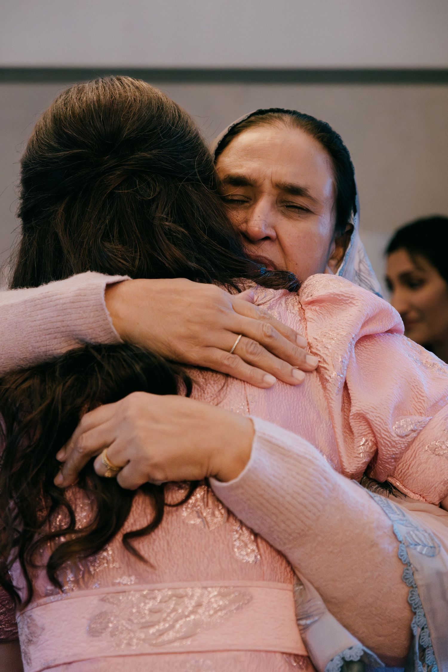 A sequence of frames showing two people sharing an intimate embrace in a dimly lit setting.