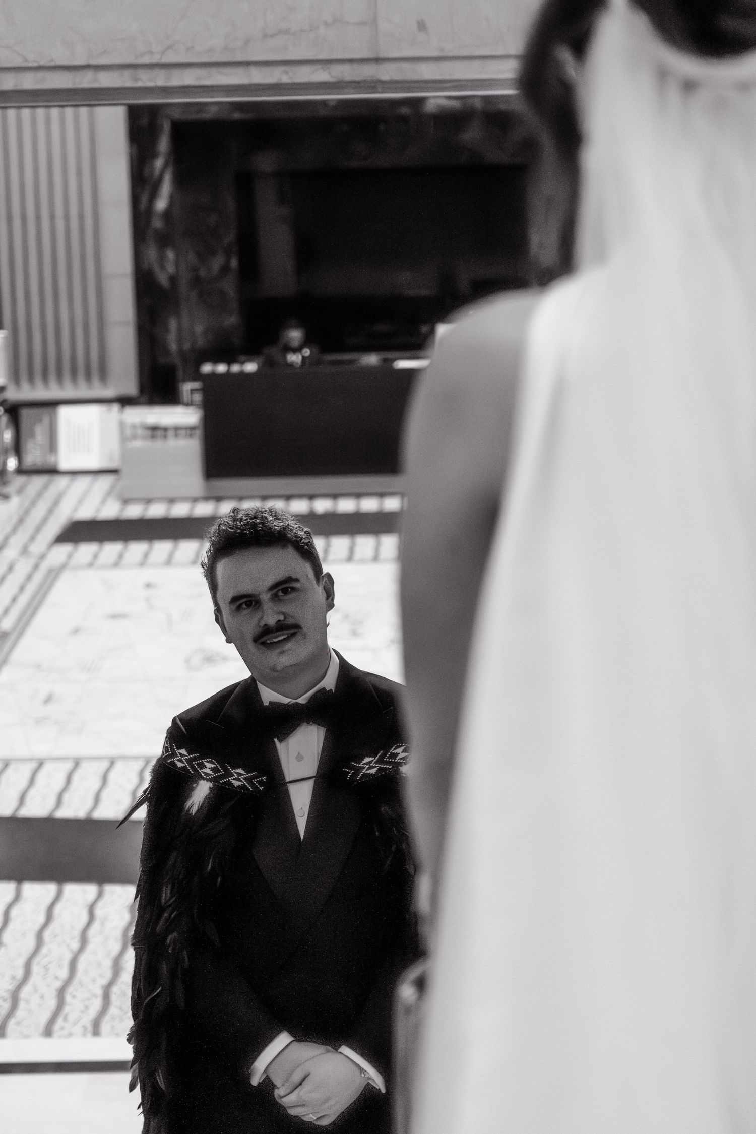 A black and white wedding photo sequence shows a groom in a tuxedo looking thoughtfully off to the side.