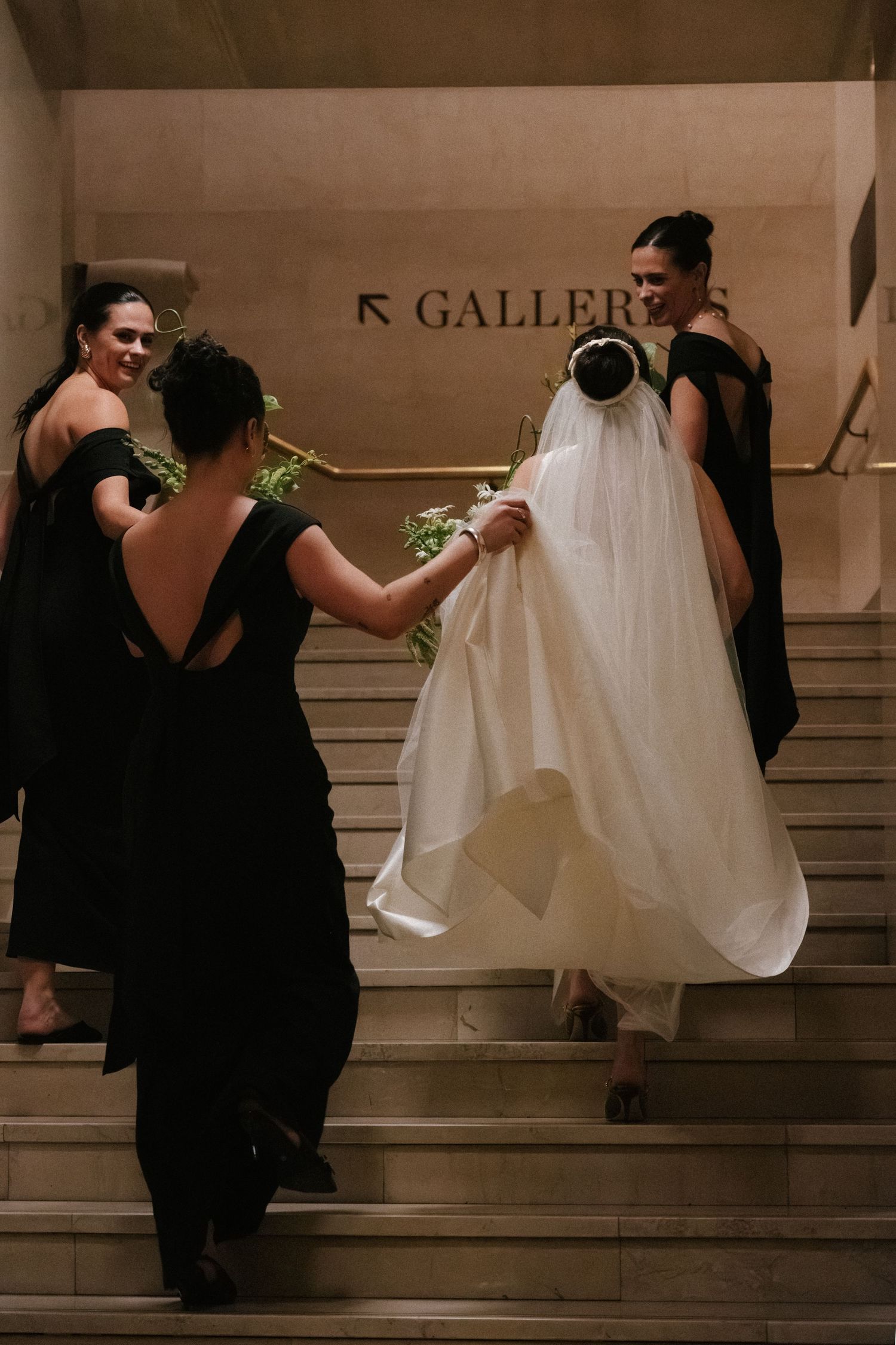 In a sequence of images, a bride's dress is lifted by bridesmaids as they help her ascend stairs in an elegant setting.
