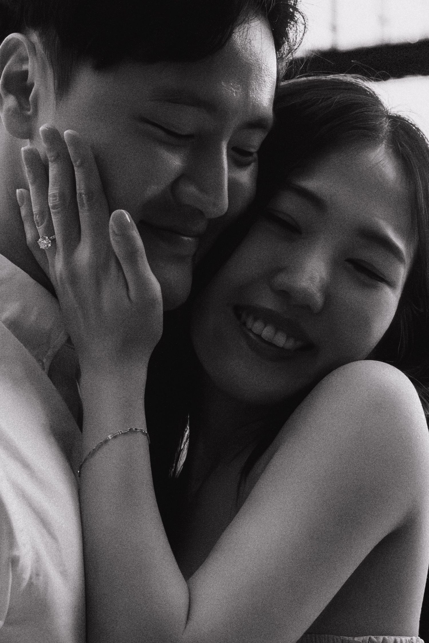A black and white photo sequence showing an intimate moment between two people sharing laughter and embraces.
