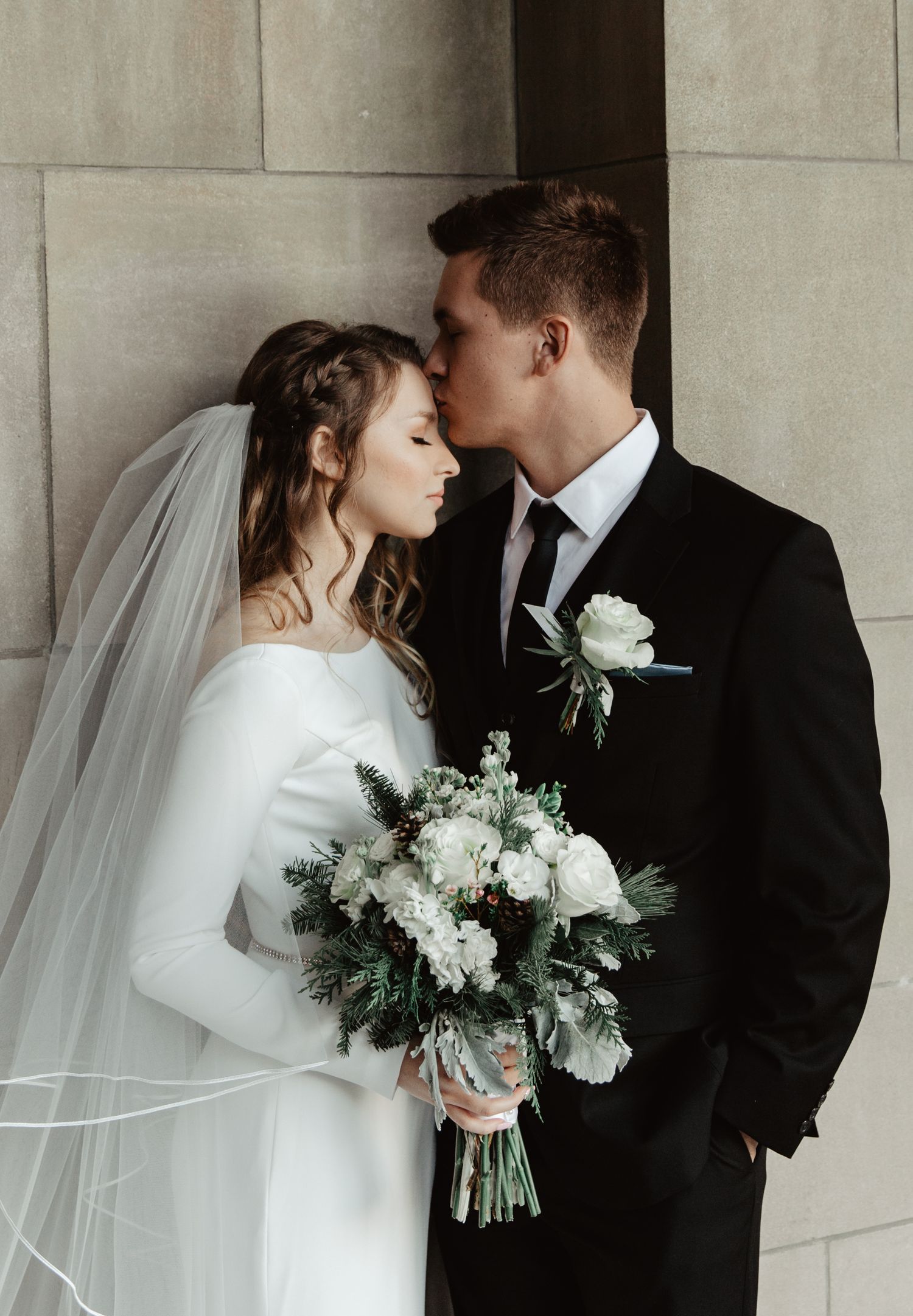 groom kissing bride at the nebraska state capitol in lincoln