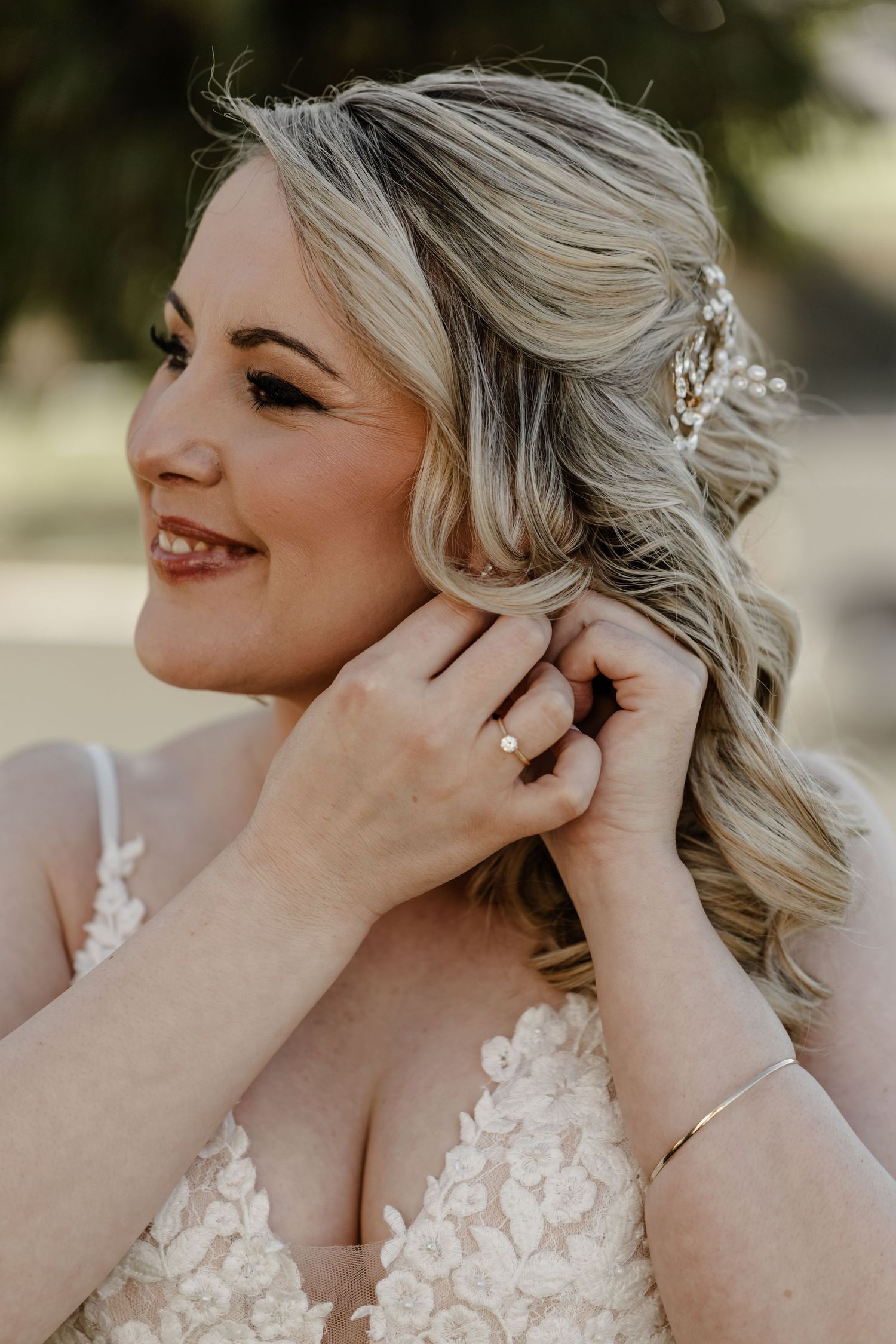 Close-up shots show a bride in white lace dress putting on pearl earrings before her wedding ceremony.