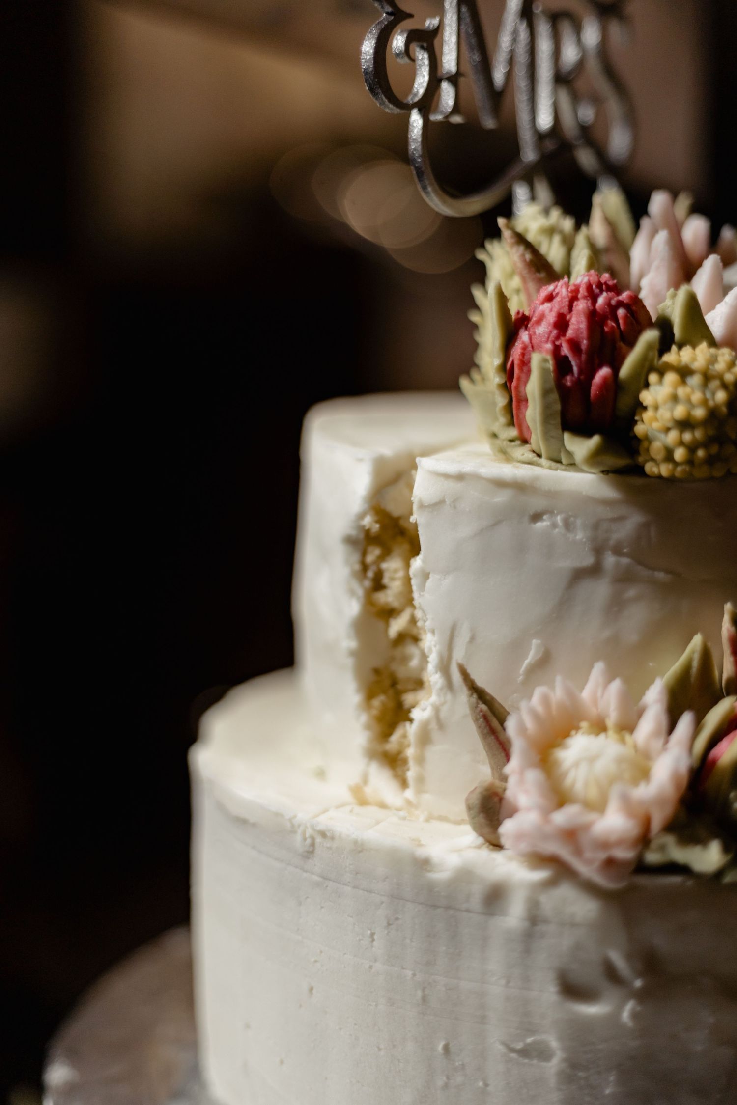 Elegant white wedding cake decorated with fresh flowers and a