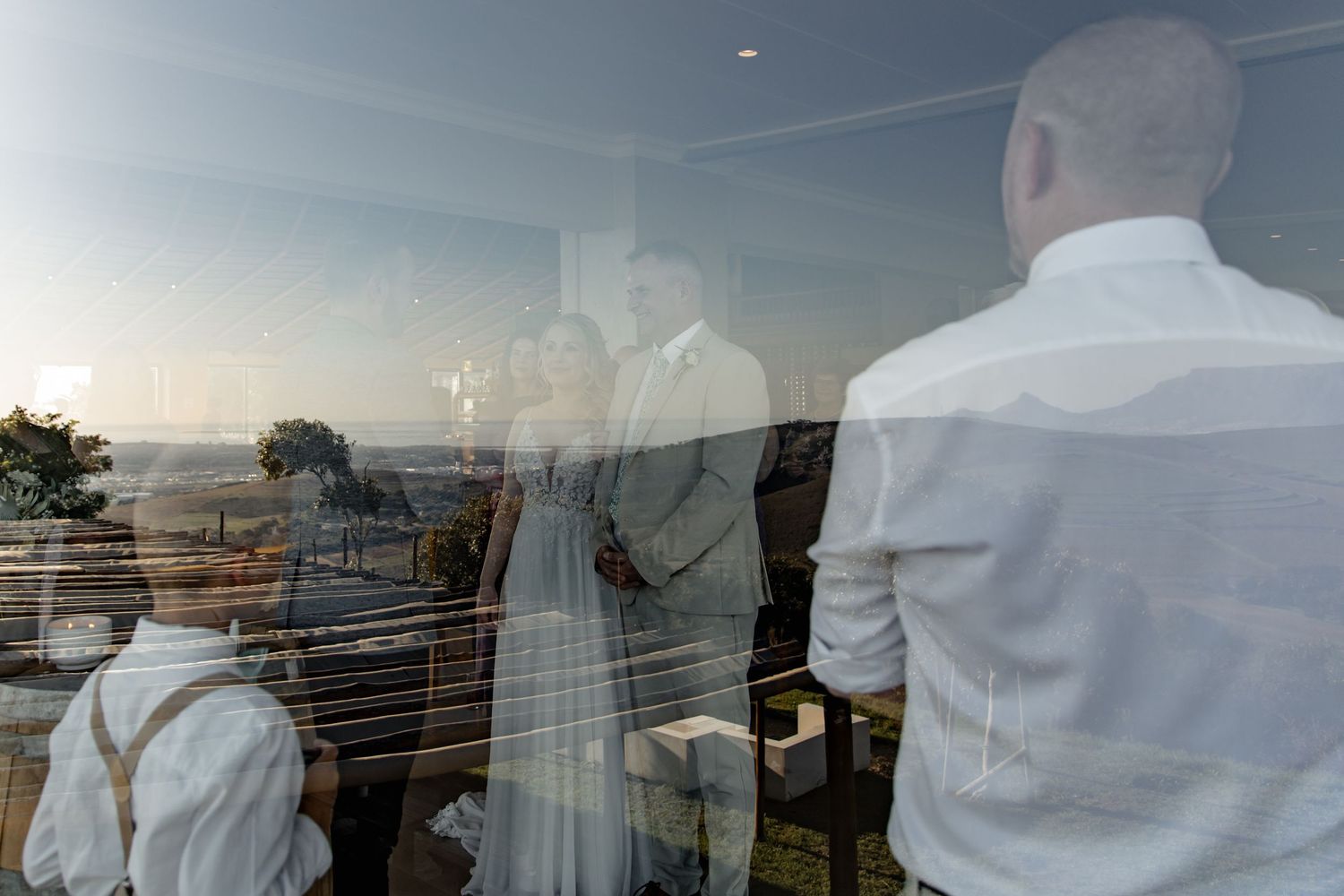 A unique panoramic sequence shows changing views of the San Francisco Bay Bridge at sunset through high-rise windows.
