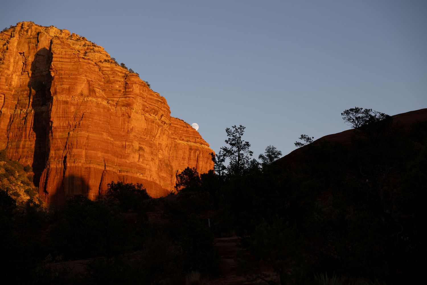 Sedona red rock landscape with the moon peeking through
