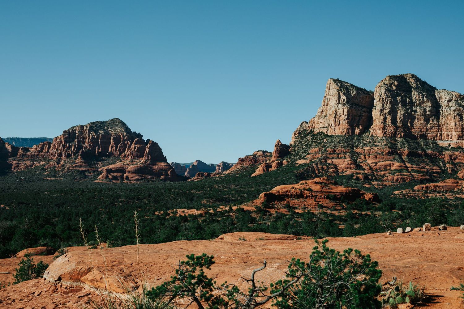 Dramatic red rock formations rise above the desert landscape in Sedona, Arizona.