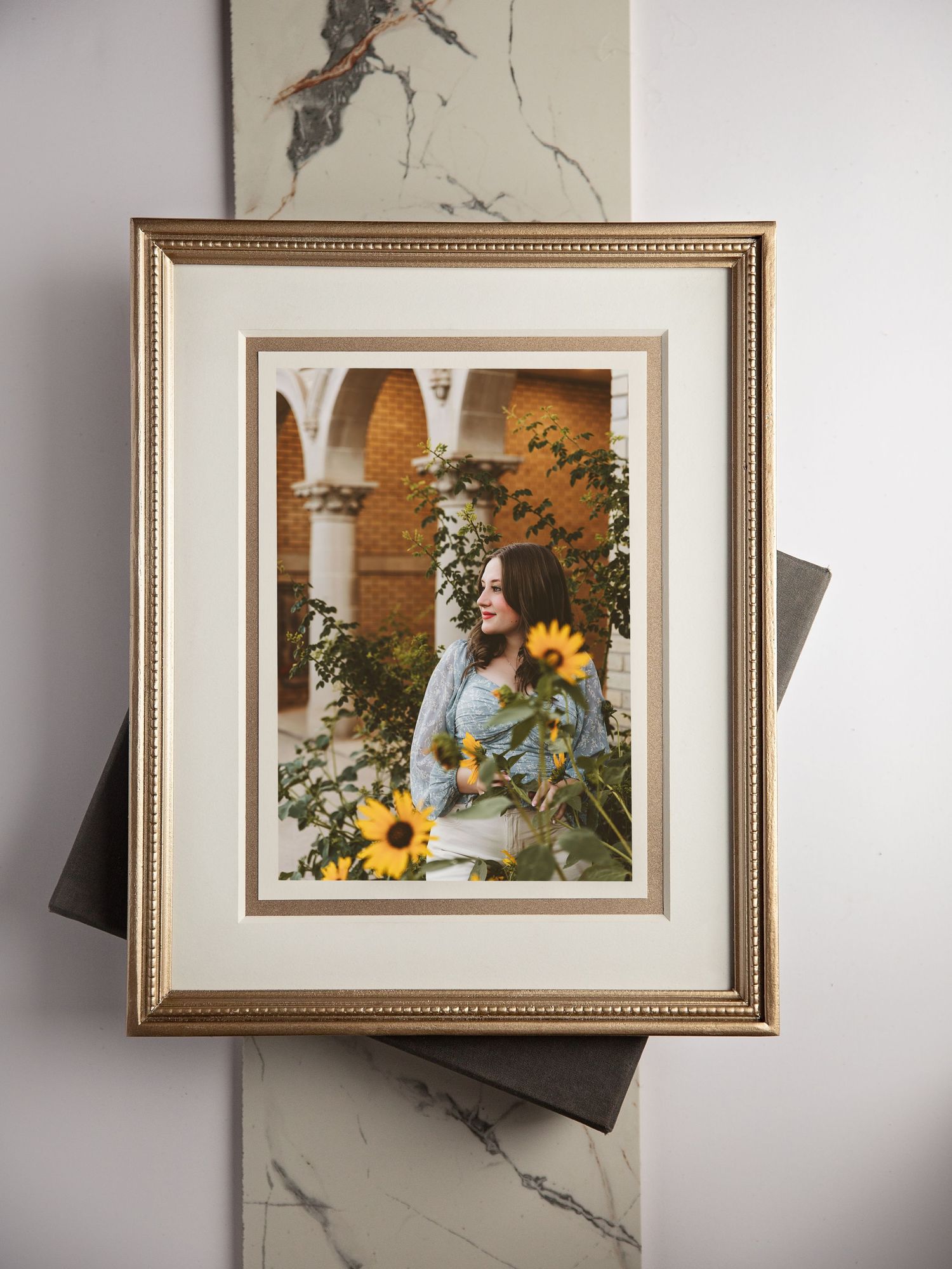 Four framed photographs showing a white rabbit with sunflowers and floral arrangements against soft backgrounds.