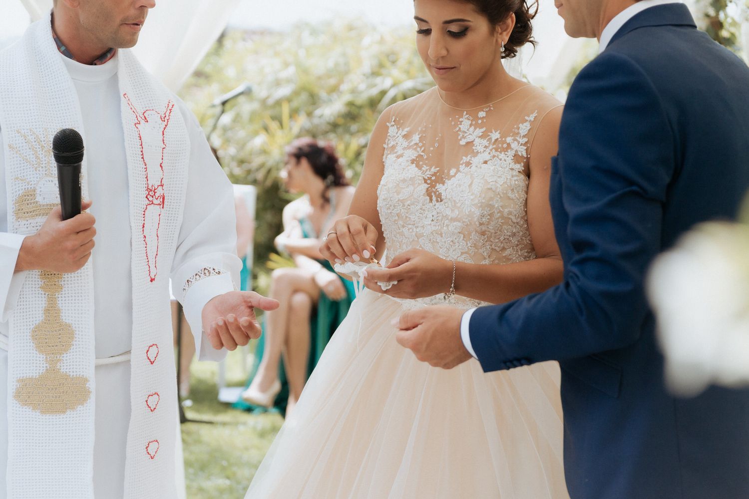 Elegant couple sharing a romantic moment during their outdoor wedding celebration in warm natural lighting.