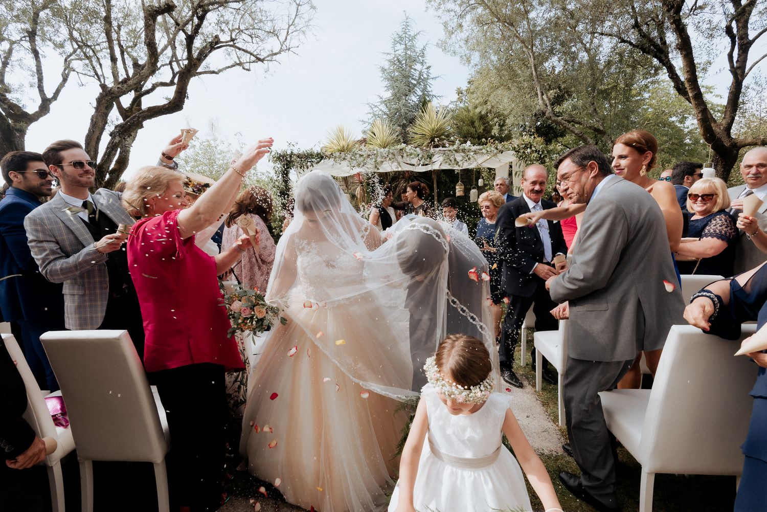 A sequence of wedding celebration moments showing dancing and joyful interactions at an outdoor venue.