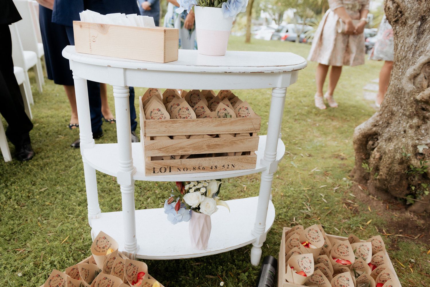 Rustic display of homemade cookies on wooden crates at an outdoor wedding dessert table.