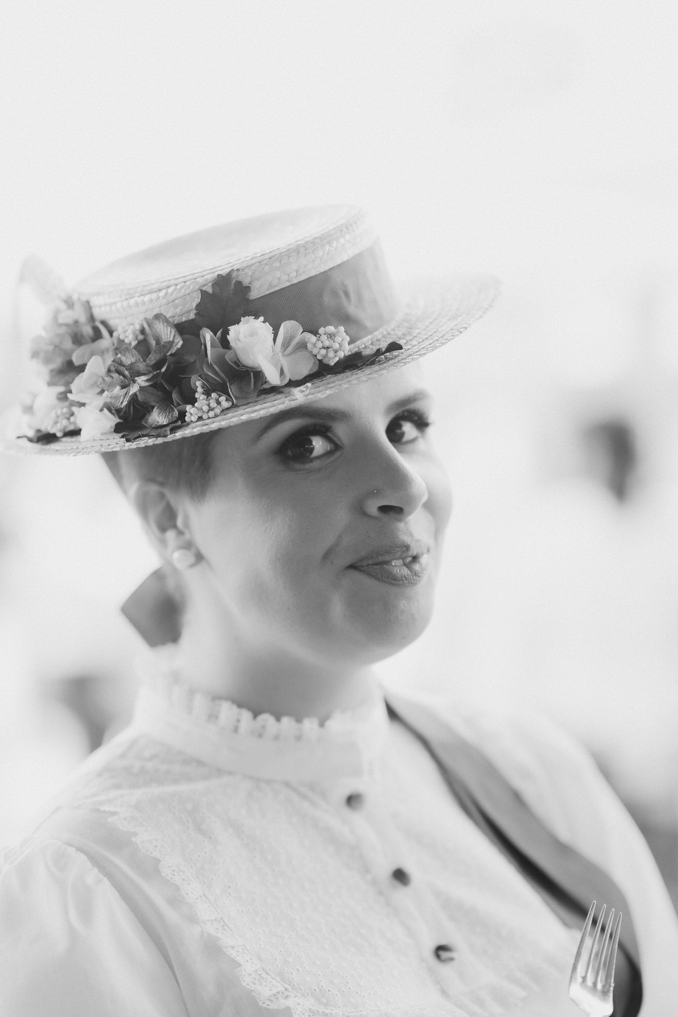 A dreamy black and white photo series features close-up profiles of someone wearing a white floral hat.
