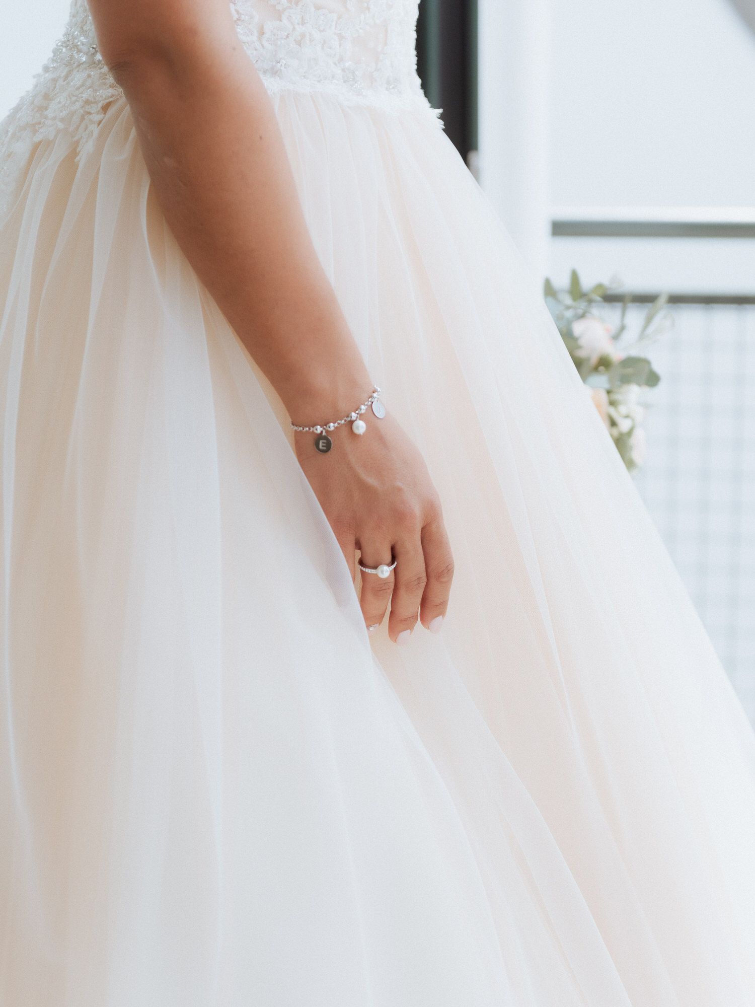 A delicate wedding dress details shot with a close-up view of the dress's intricate tulle and fabric layers.