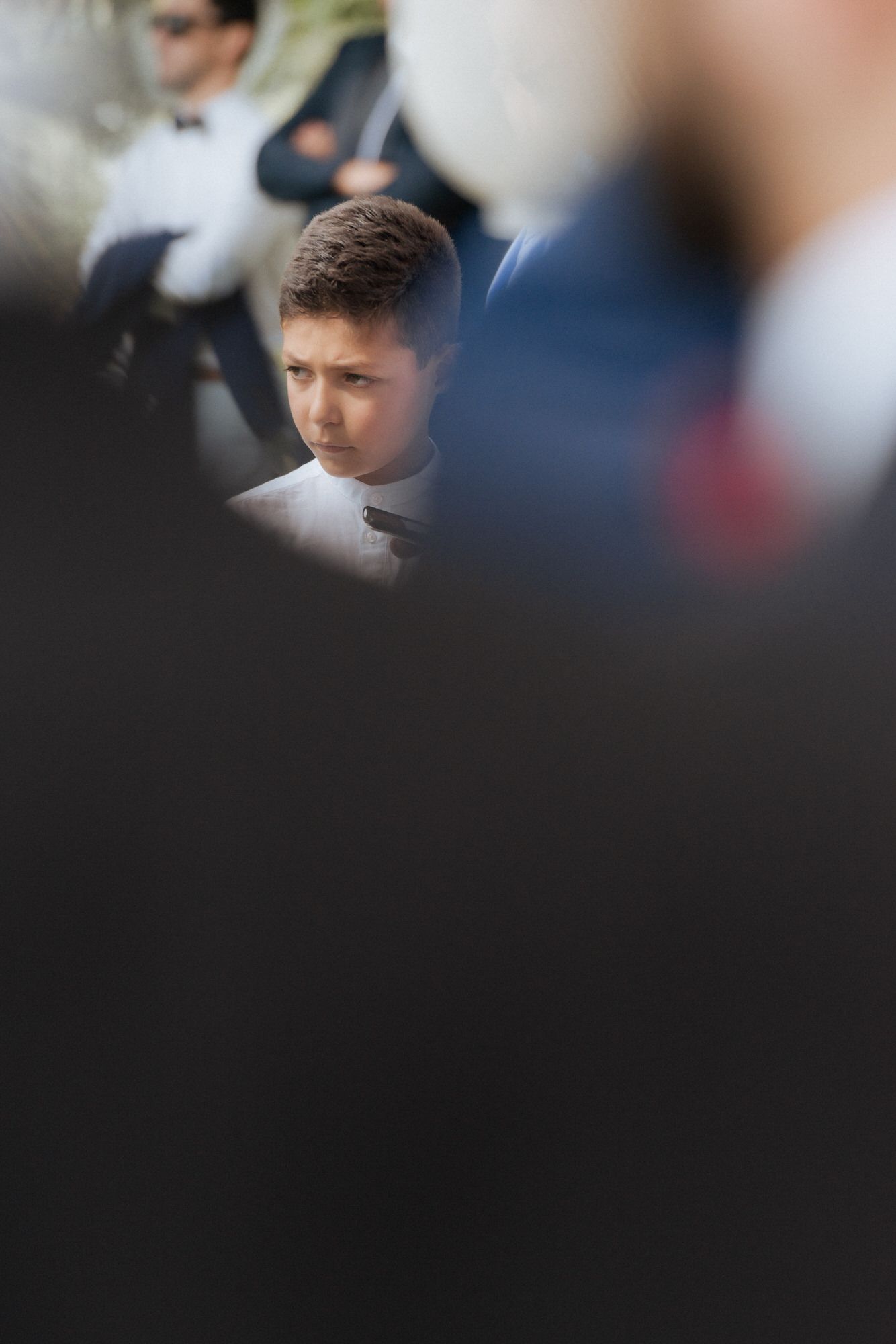 A montage of blurry portrait shots showing figures against dark and light backgrounds with varying degrees of focus.