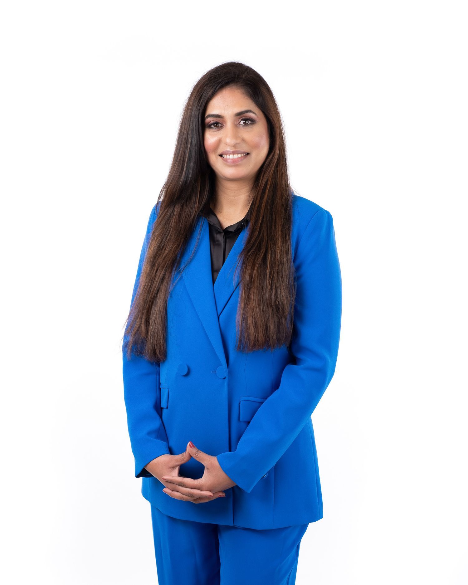 Business professional wearing vibrant royal blue power suit against white background.