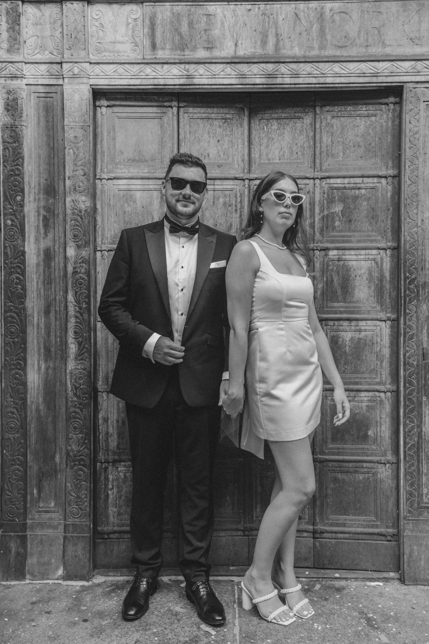 Chic couple celebrating outside of city hall after NYC marriage