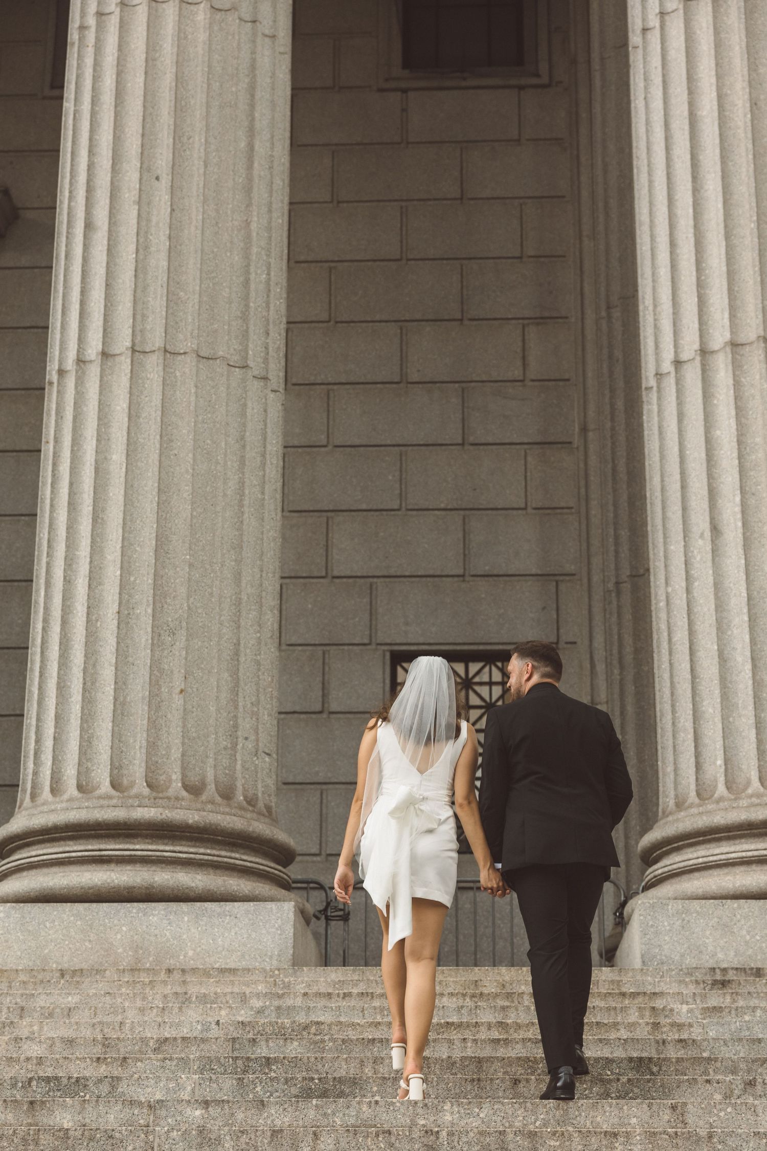 Editorial couple on the front steps of the courthouse after NYC elopement