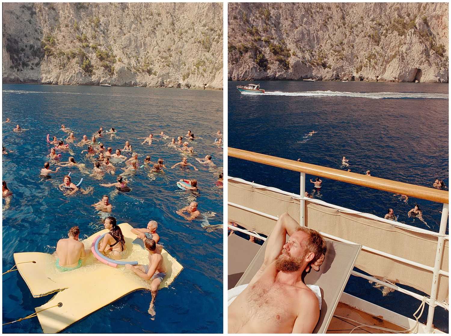 People swimming and relaxing on a floating platform near rocky cliffs in blue Mediterranean waters.
