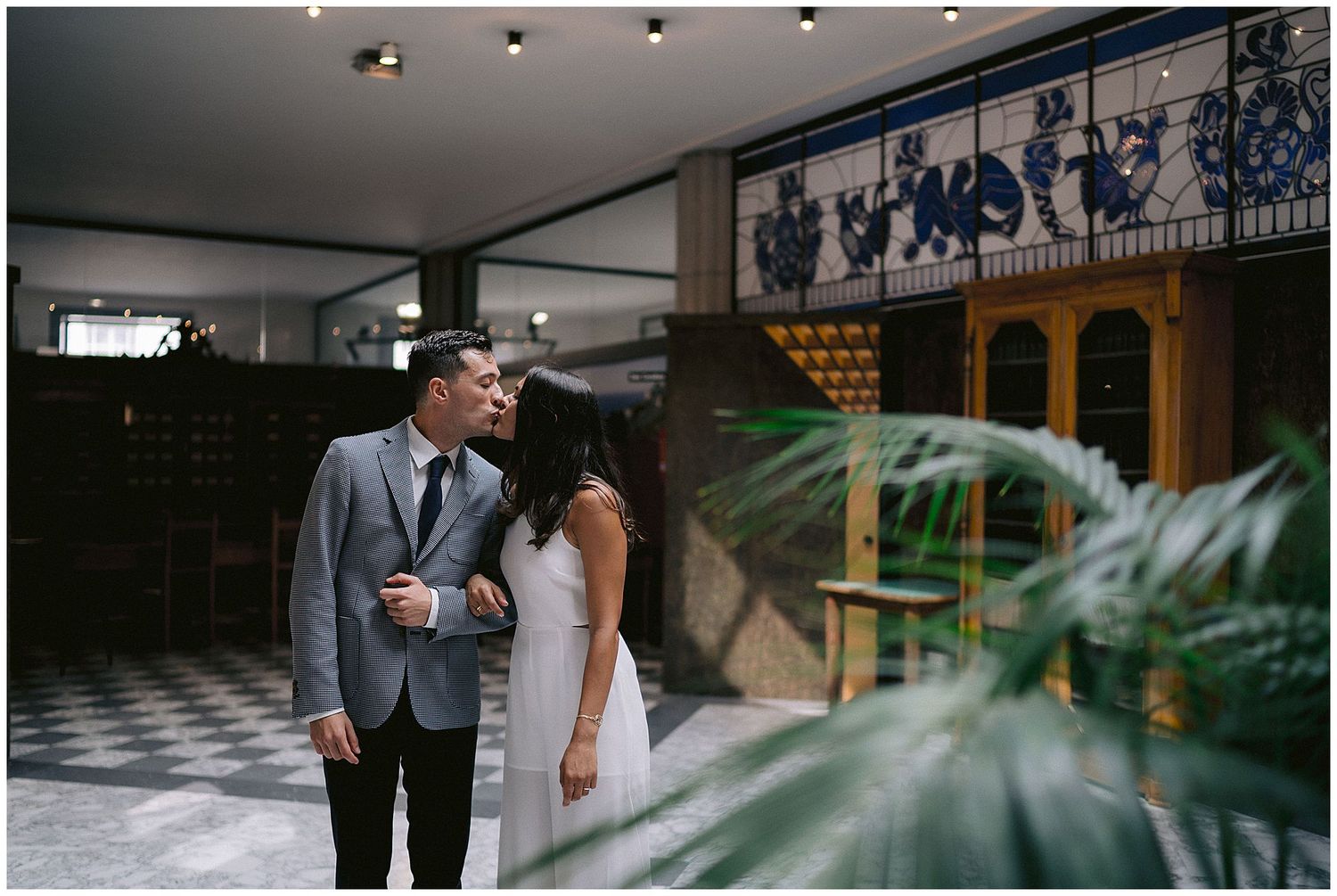A wedding venue decorated with elegant glass chandeliers and ornate window designs creates a romantic ambiance.