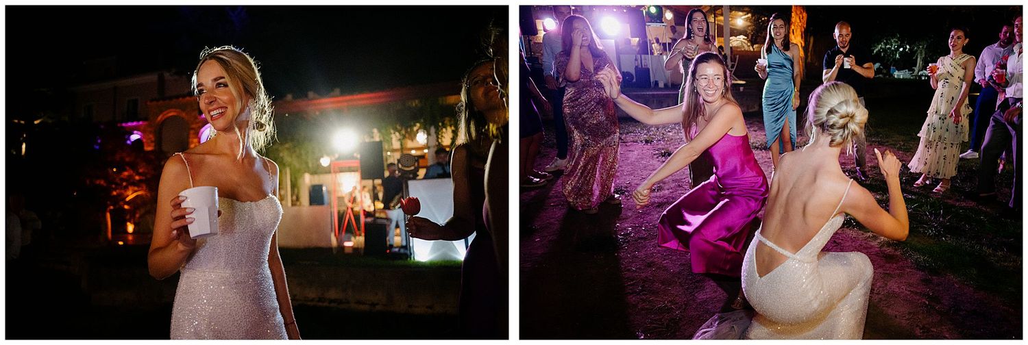 Bride in white dress dancing and enjoying herself at an evening wedding reception with colorful purple lighting.
