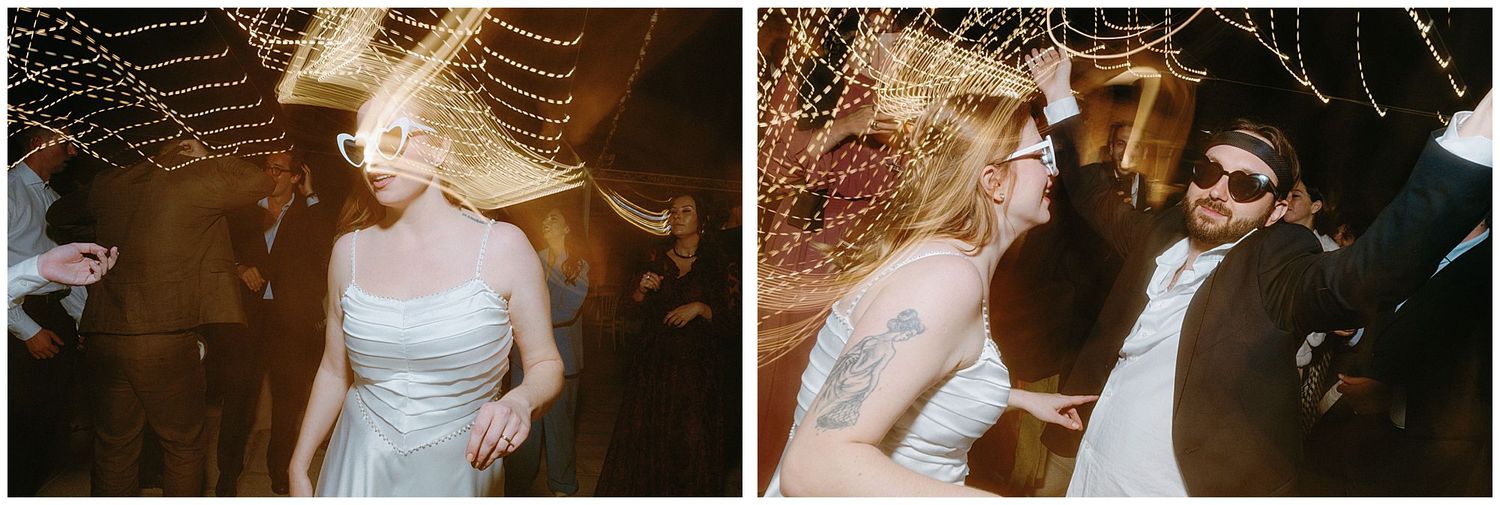 Couple dancing and celebrating on their wedding night under romantic string lights at an indoor reception venue.