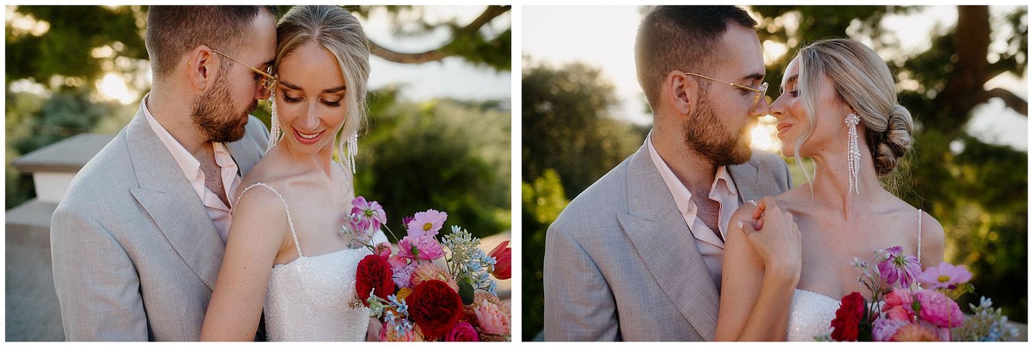 Couple shares romantic embrace in golden sunset light with pink floral bouquet in garden setting.