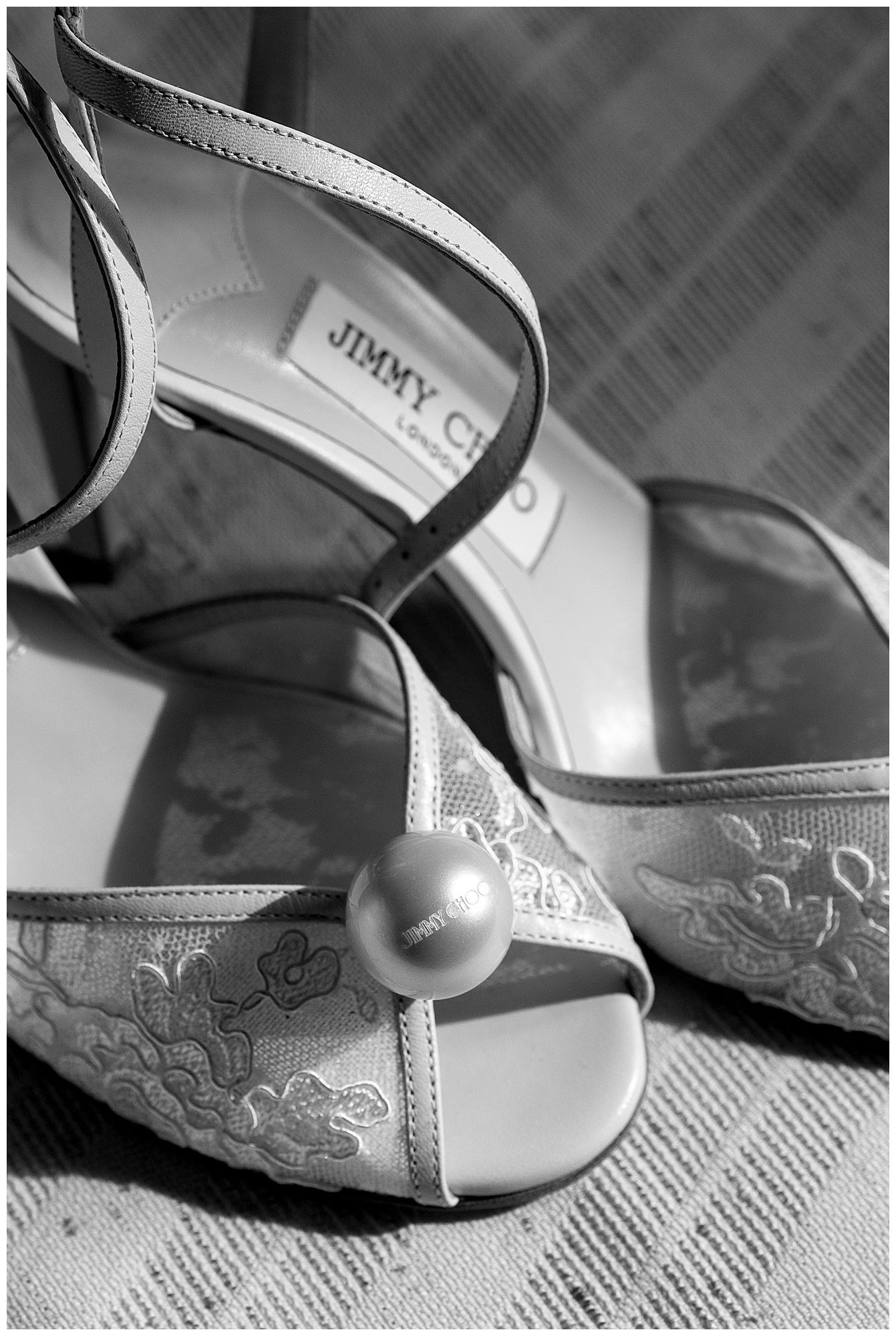 A close-up series of black and white photos showing details of an elegant bridal shoe with floral embroidery pattern.