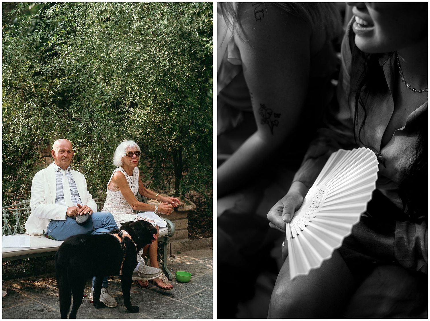 Two people and a black dog sit together outdoors while a hand holds a white folding fan in black and white.