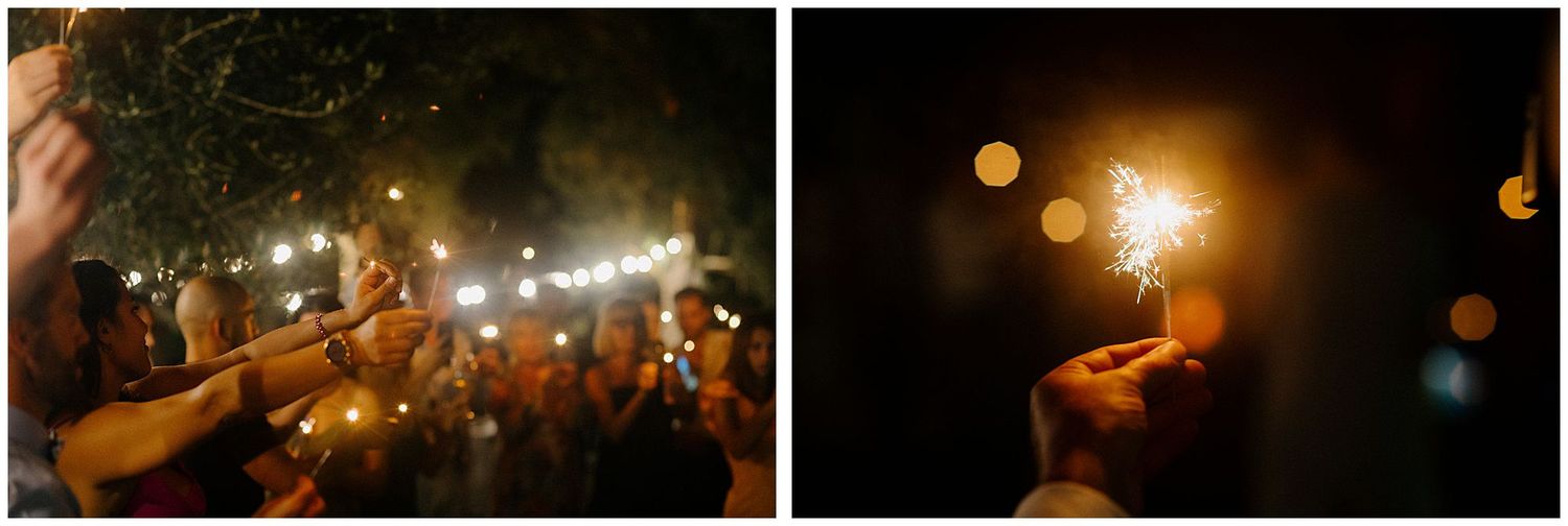 Multiple lit sparklers glow brightly against a dark nighttime setting, creating a magical atmosphere with bokeh effects.