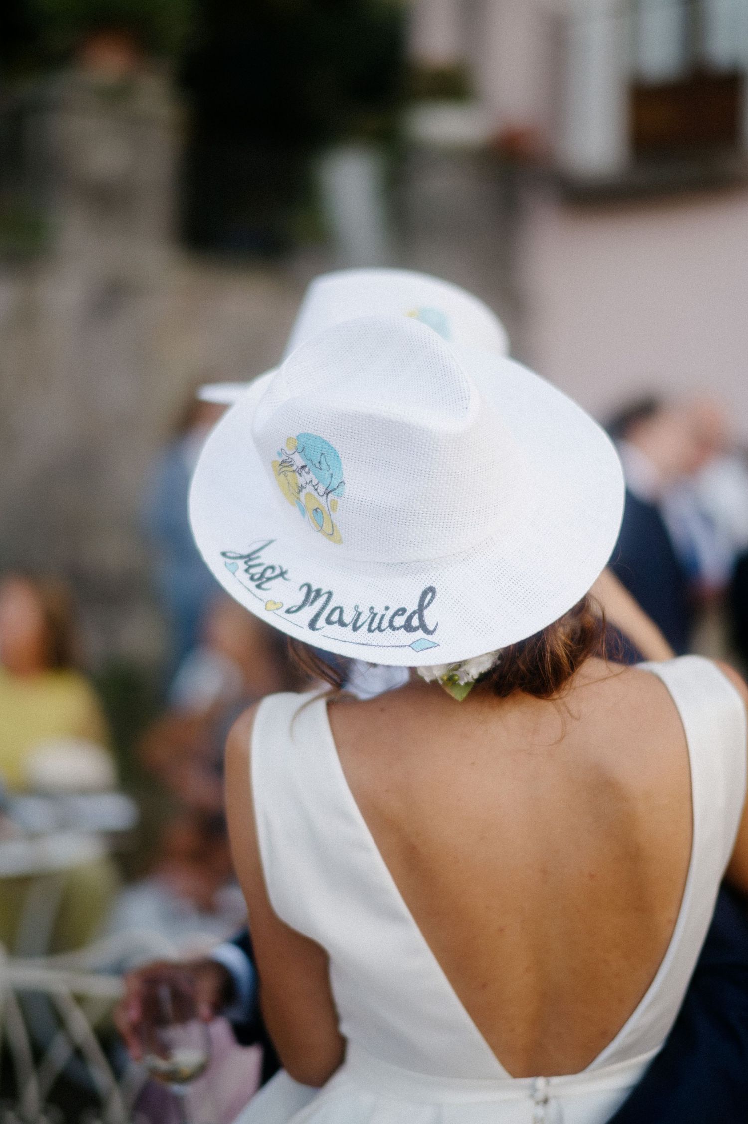 Person wearing a white wedding dress with open back and