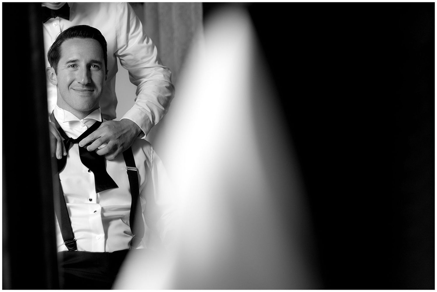 Black and white portraits showing loving tenderness between newlyweds in elegant wedding attire.