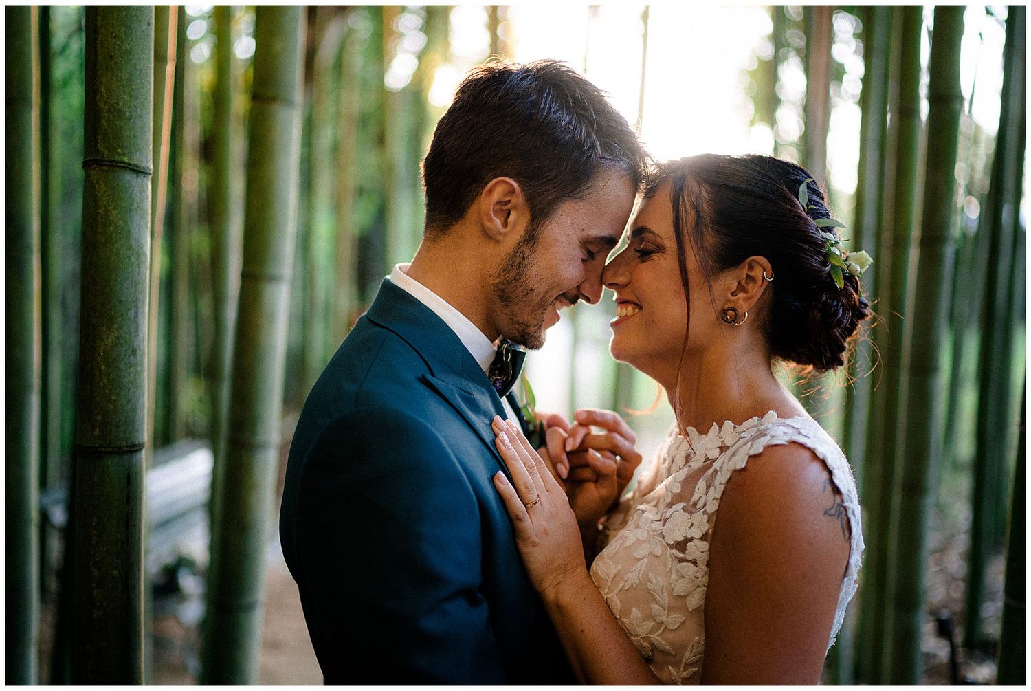 Romantic moment between newlyweds standing in a serene bamboo forest.
