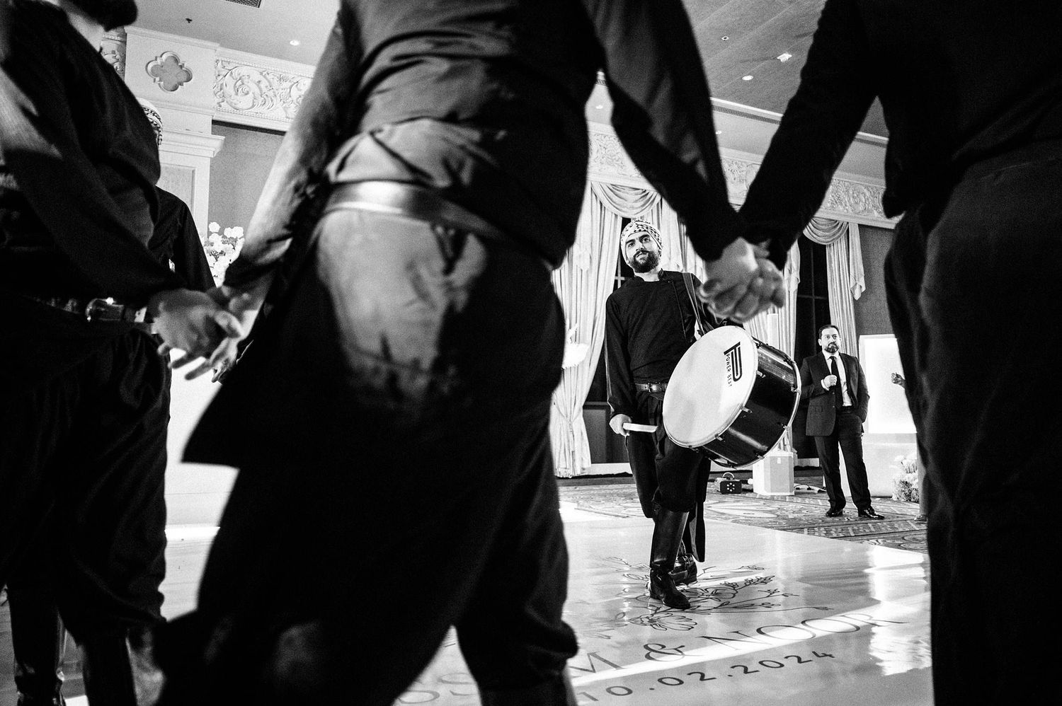 Black and white street photograph showing protesters and a person with a drum in downtown New York City.