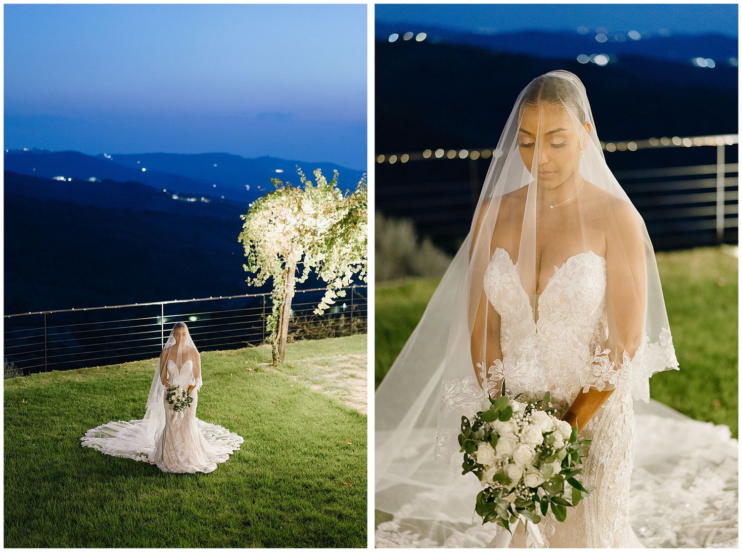 A bride in a white lace gown and veil poses outdoors at dusk with mountain views and illuminated floral arrangements.