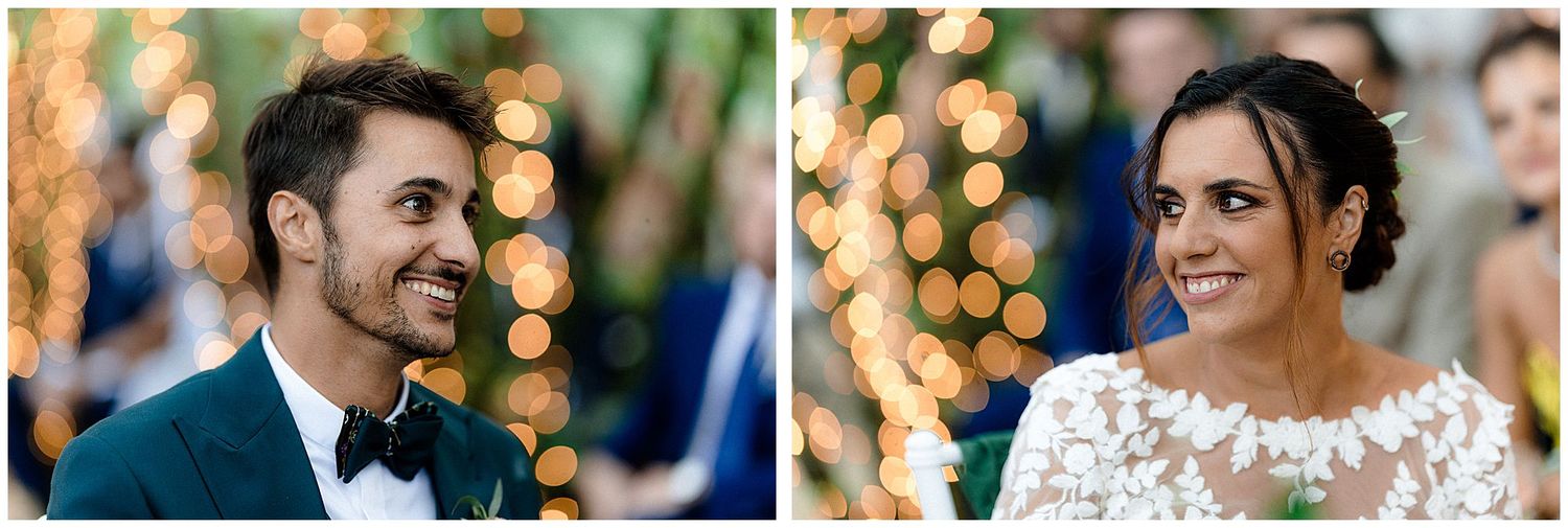 A couple shares a joyful moment at their wedding with festive lights creating a magical backdrop.
