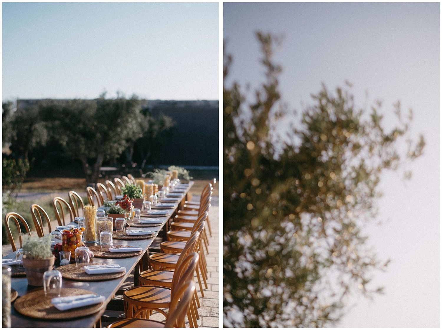 Long wooden dining table set up outdoors with white place settings and cross-back chairs for an elegant wedding reception.