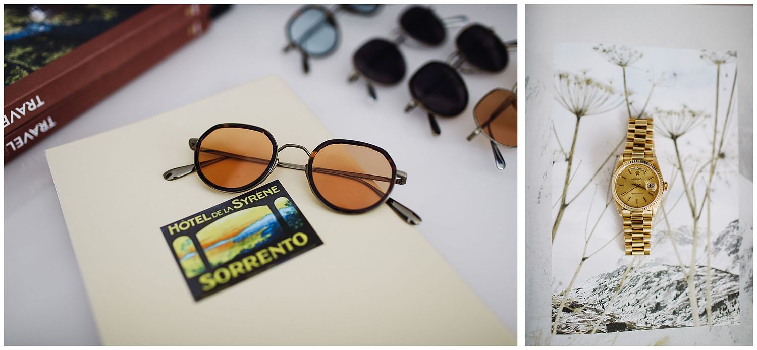Vintage round sunglasses and gold watch arranged with travel memorabilia for lifestyle photography.