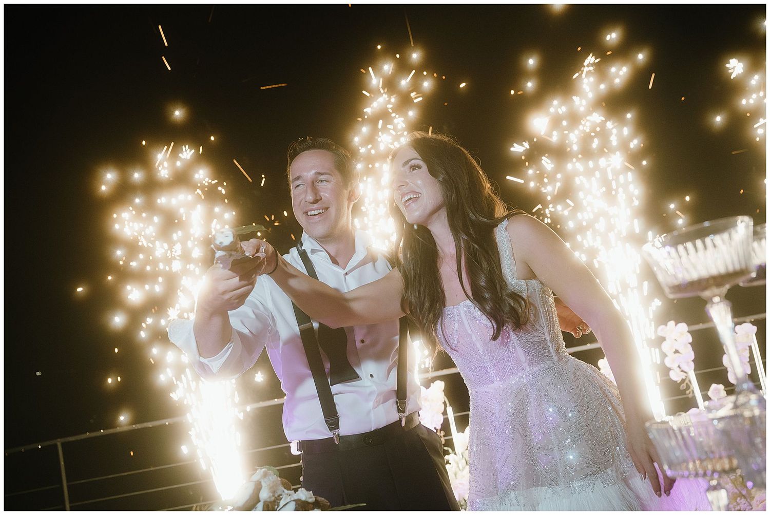 Sparklers create a magical moment on the dance floor as a couple celebrates at their wedding reception.