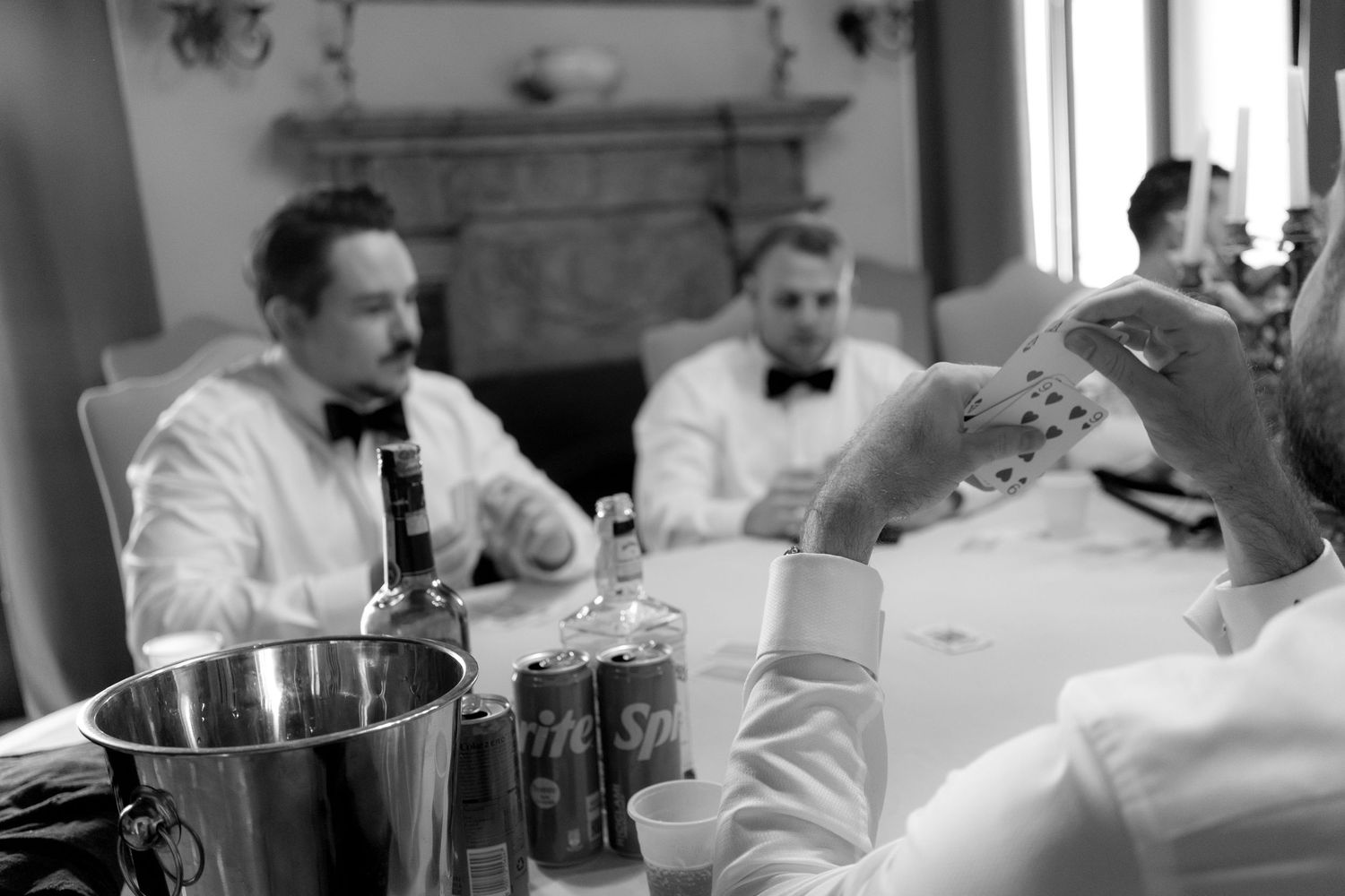 Vintage black and white scene of guests in formal attire seated at an elegant dining table with champagne.
