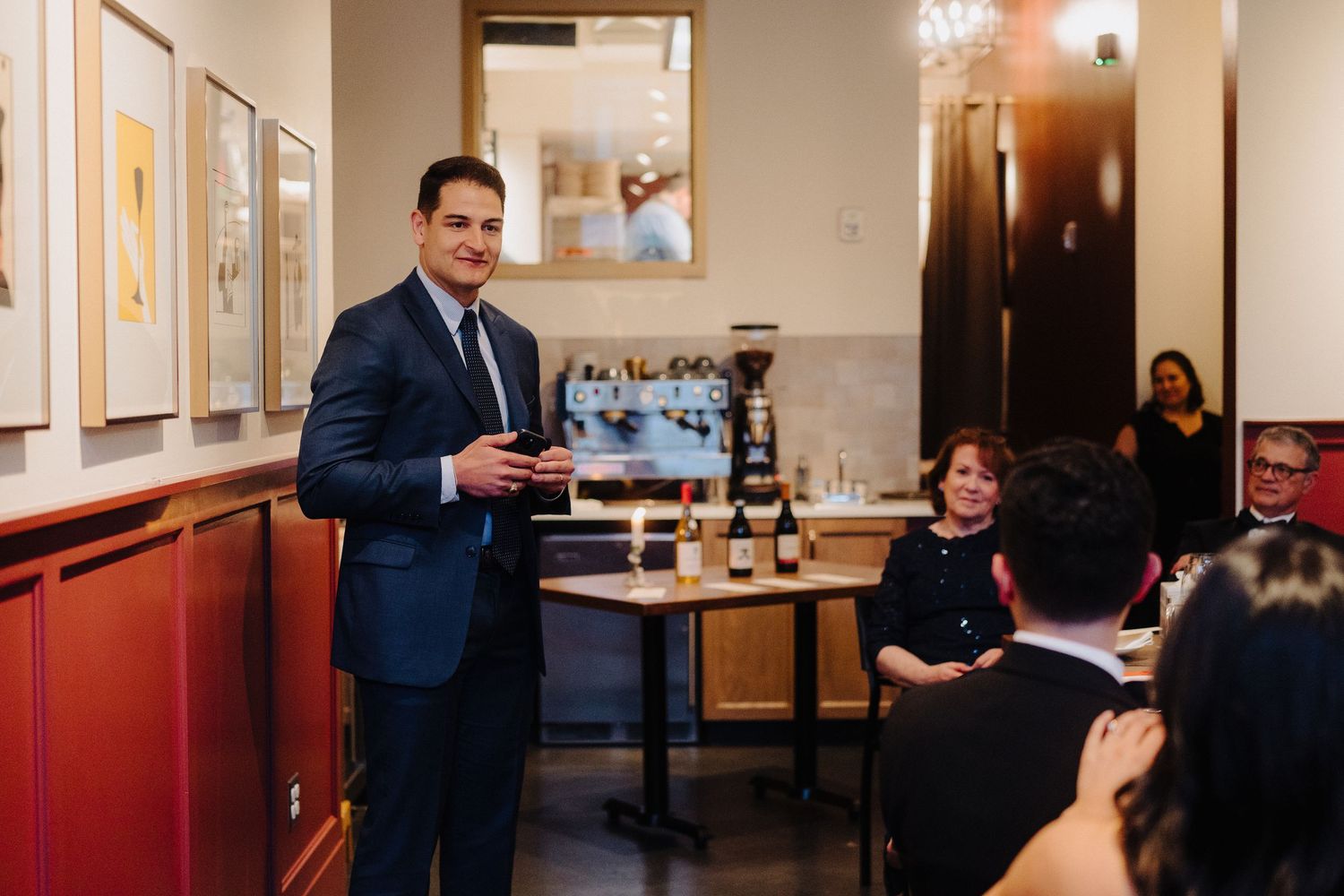 Presenter speaking during wine tasting event at an upscale dining venue.